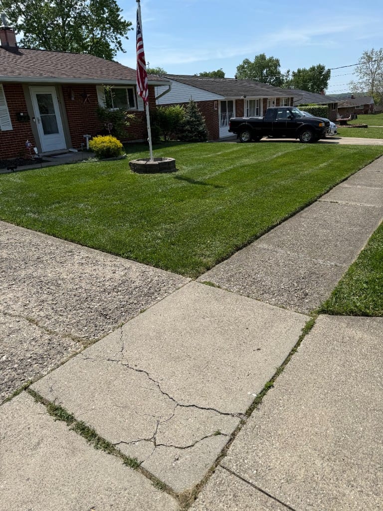 Professional striped lawn mowing with American flag – residential lawn care Batavia Clermont County Ohio
